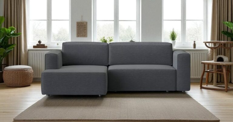 Pet hair resistant furniture: Moved Night modern grey fabric sofa placed in a bright pet-friendly living room with wooden floor, neutral rug, green plants, and a cat tree by the window.